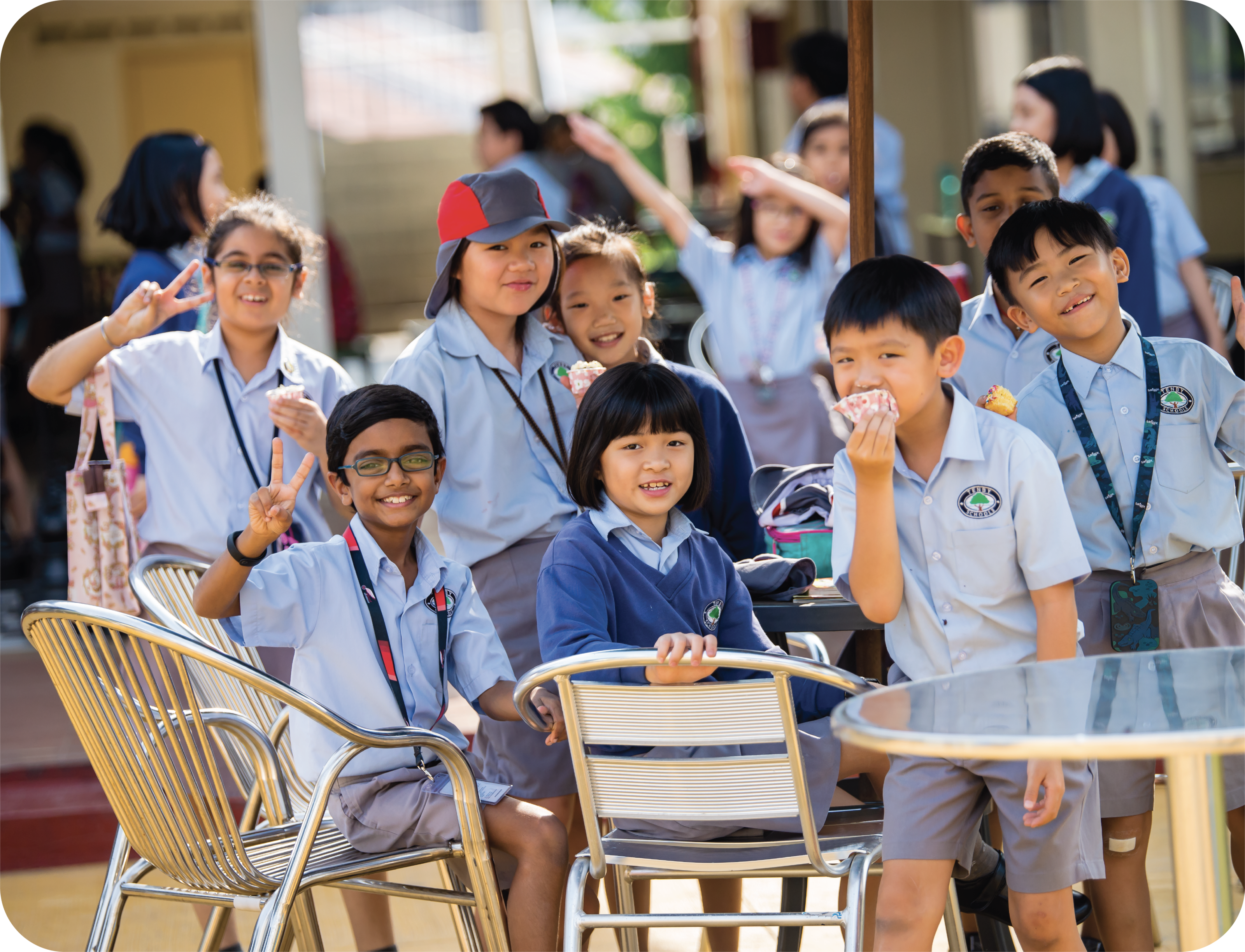 Young students smiling while sitting at a table