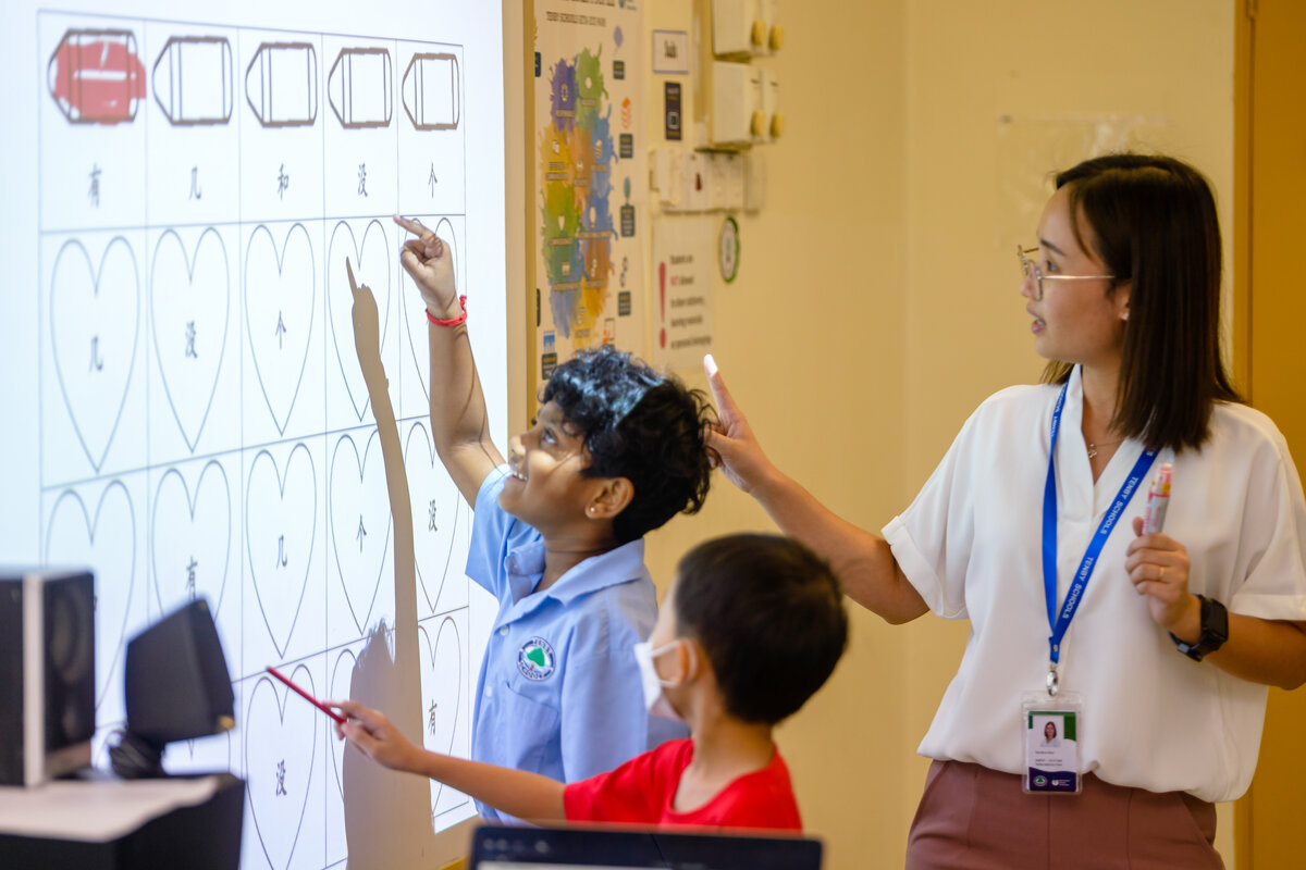 Young student smiling and learning with her teacher
