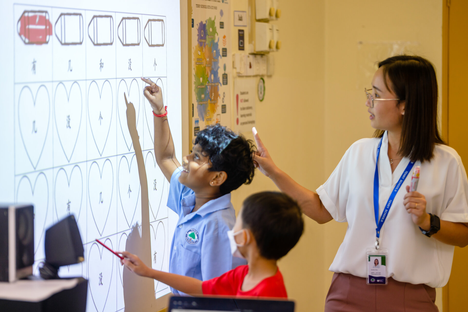 Young student smiling and learning with her teacher
