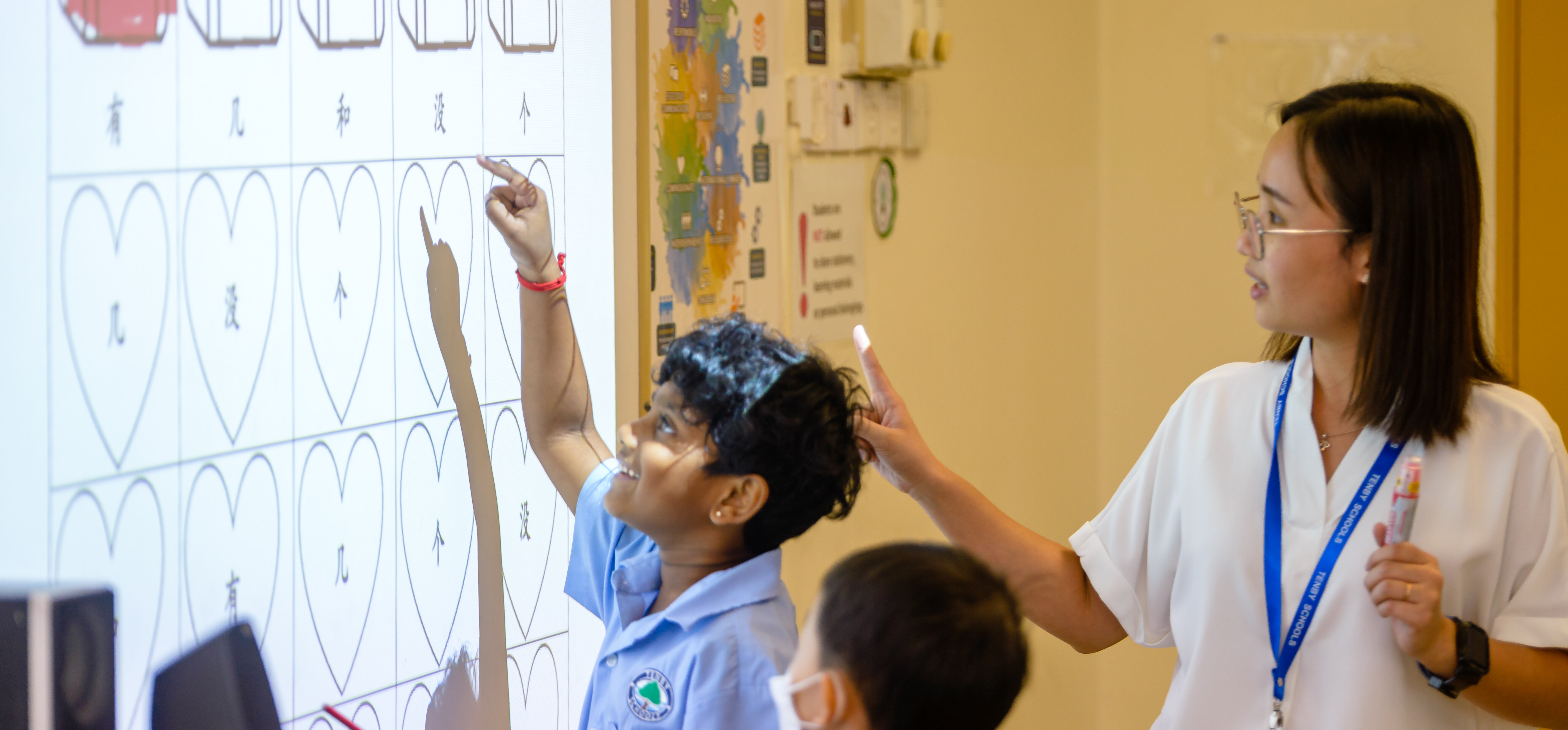 Young student smiling and learning with her teacher