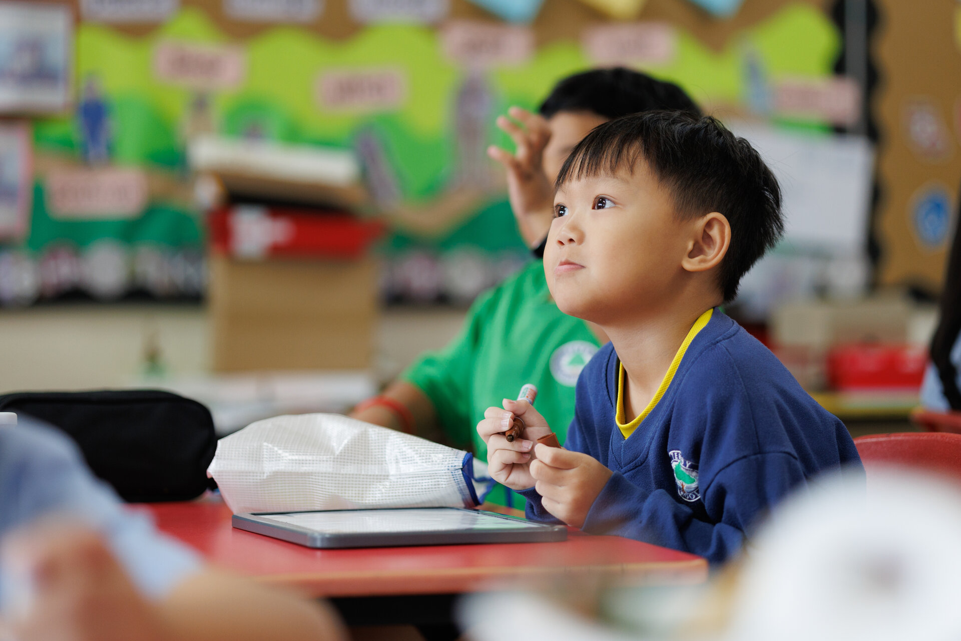 Young student with a marker in his hand