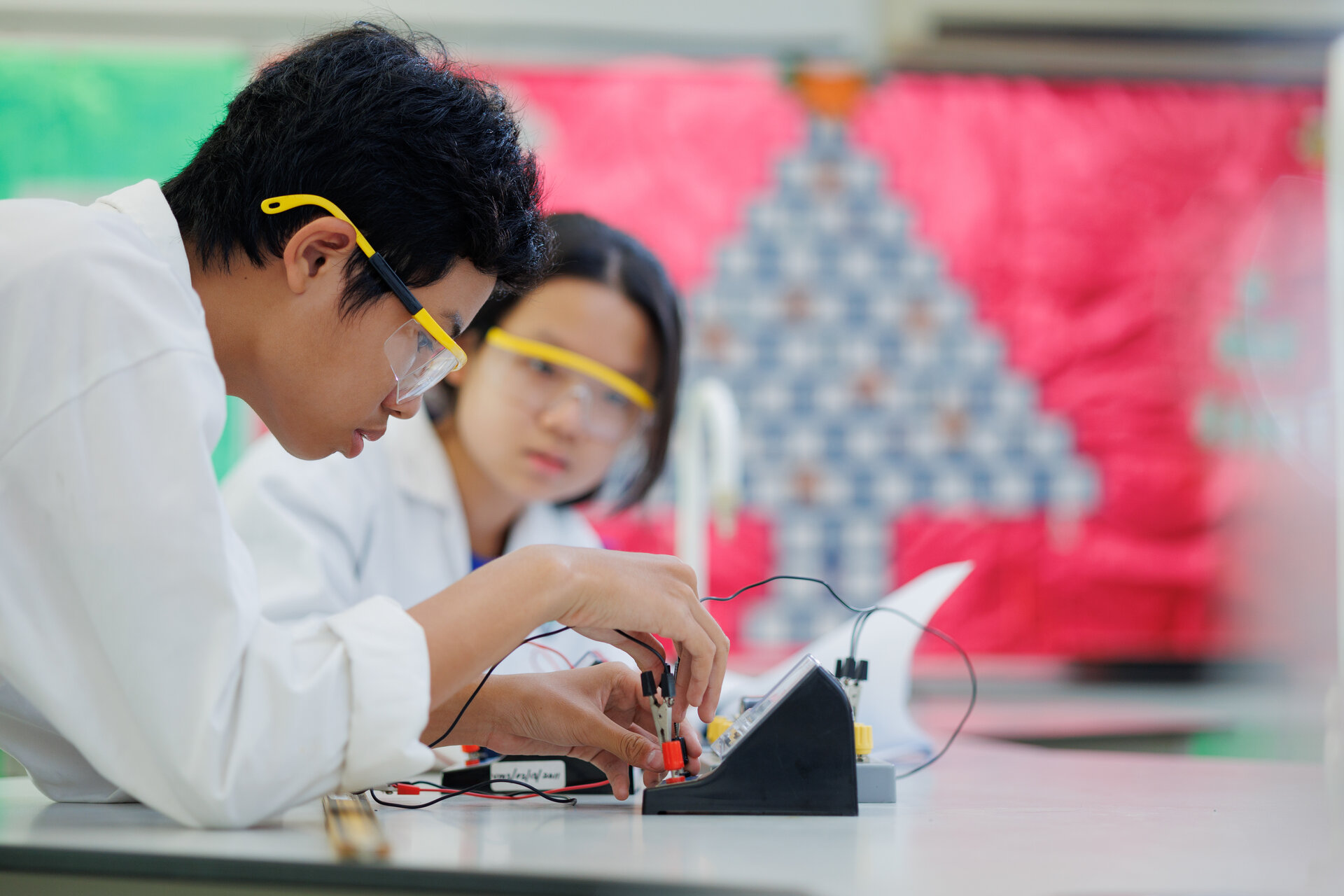 Teenagers testing an electronical device