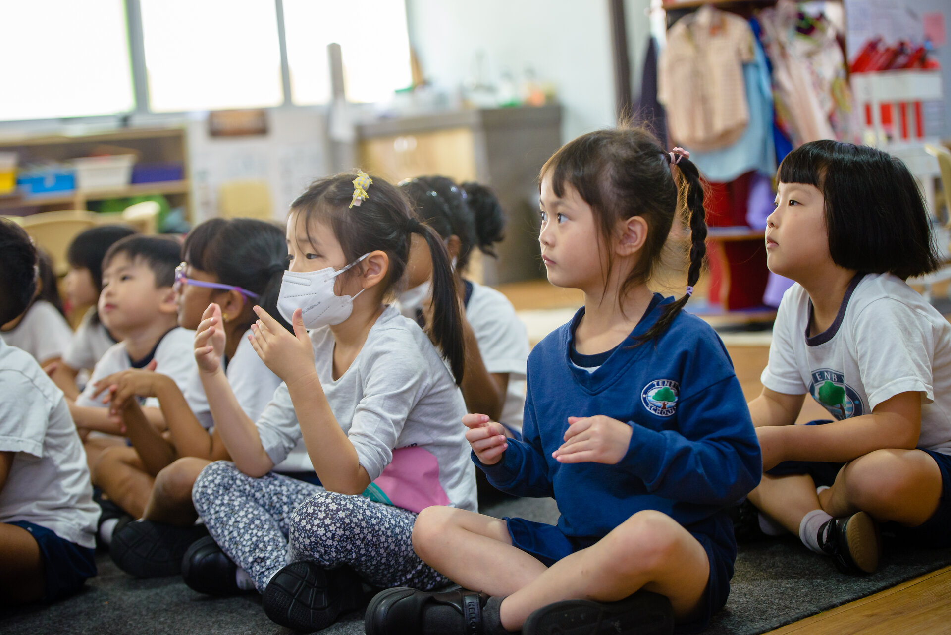 Young students sitting with their legs crossed