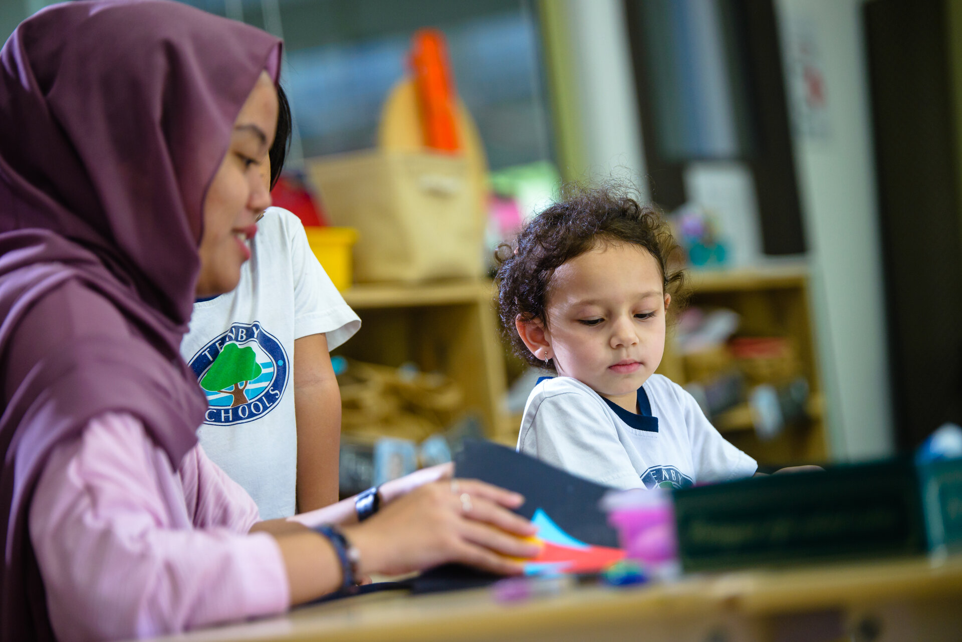 School teacher helping a student